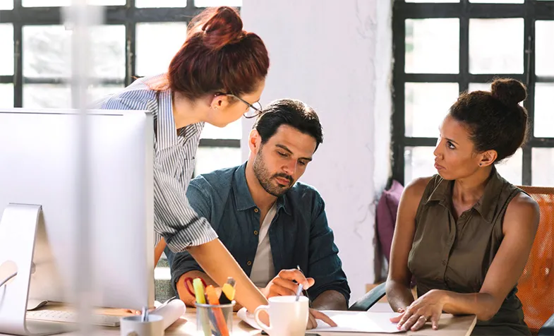 Three people meet to strategise about clear communication